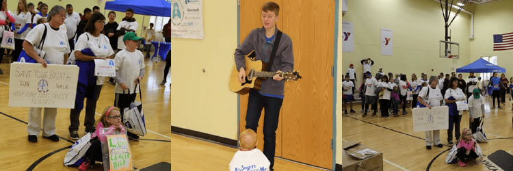 Entertainment and signs at Save Your Breath 5K.